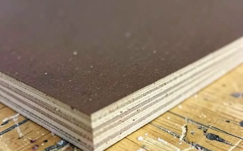 phenolic film surface on WPF plywood close-up of dark brown phenolic film surface on WPF plywood edge