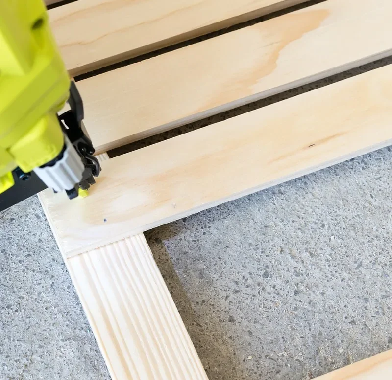 Brad nailer tip fastening a thin wood strip Brad nailer tip fastening a thin wood strip, the kind of narrow trim that suits 18-gauge nails
