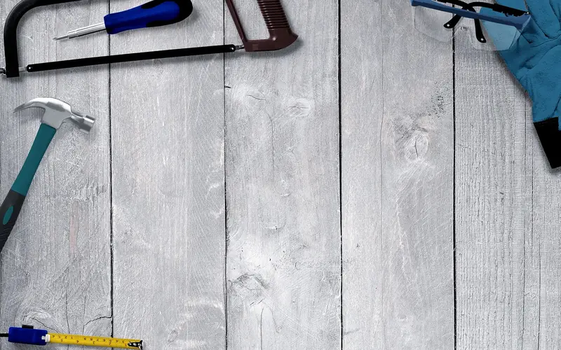 Safety glasses, gloves, and a tape measure laid out before ripping a narrow board