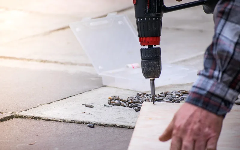 Drilling a centered pilot hole into plywood before inserting a screw extractor Drilling a centered pilot hole into plywood before inserting a screw extractor