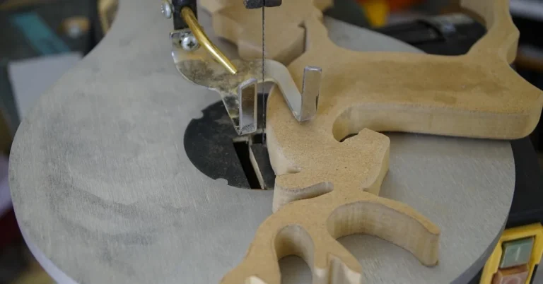 scroll saw cutting an intricate wooden letter-style shape from MDF board