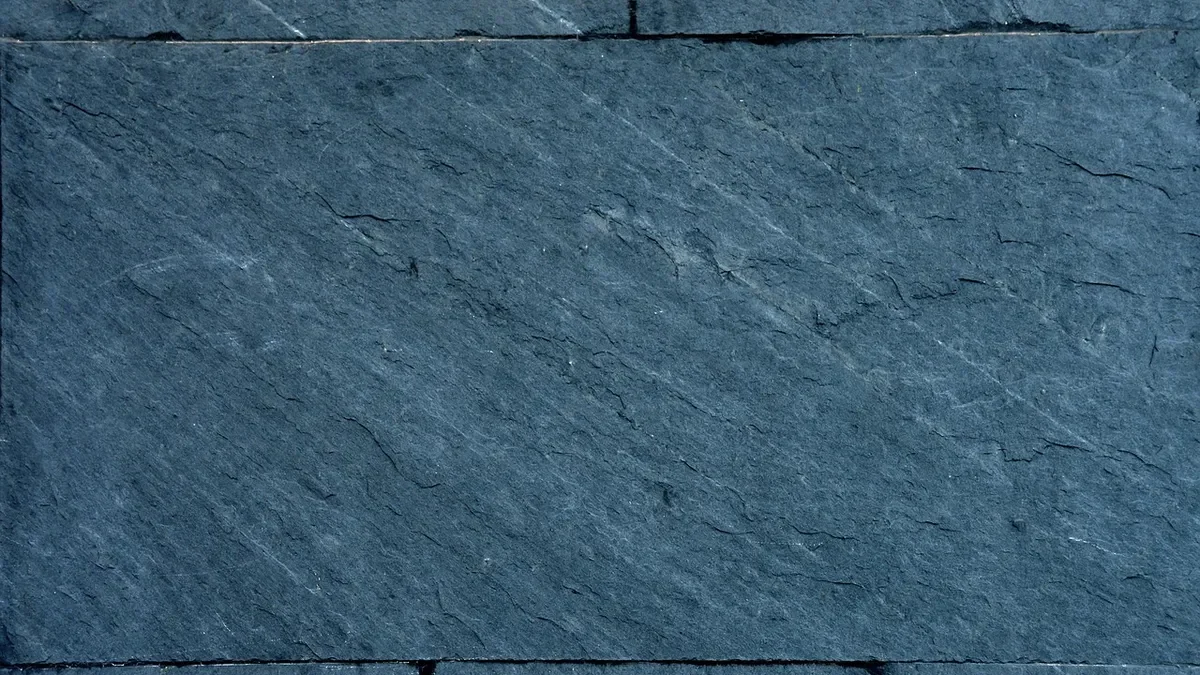 Close-up of a natural cleft slate tile surface with fine layered texture