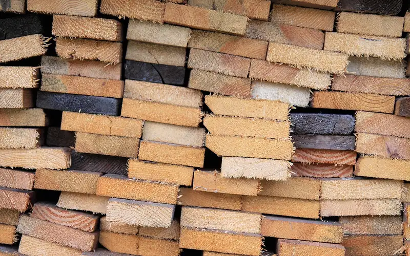 stack of cut lumber boards ready to load into a truck bed stack of cut lumber boards ready to load into a truck bed