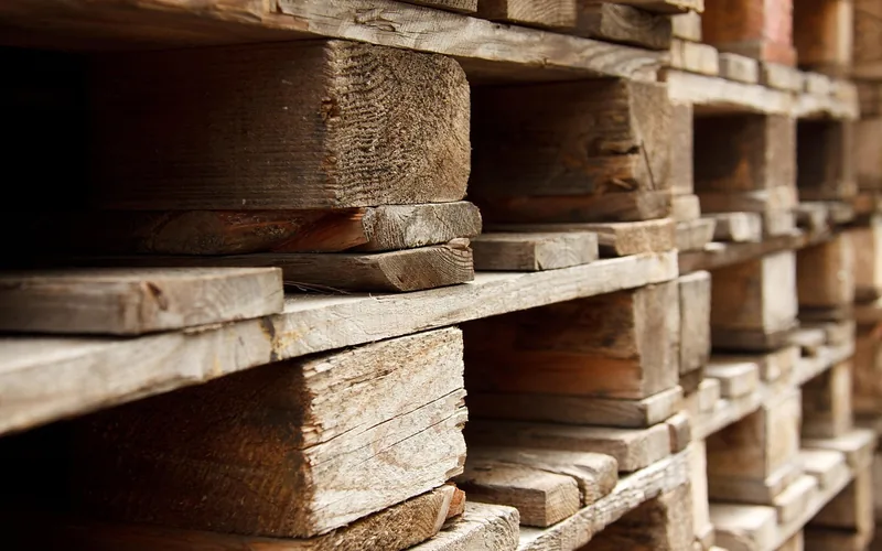 stacked wood shipping pallets awaiting heat-treatment stamp inspection