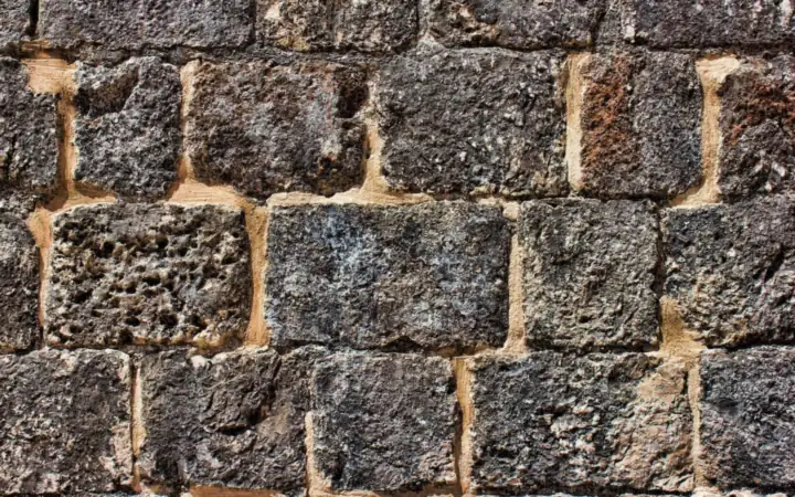 Solid stone masonry wall built from large dressed blocks with mortar joints