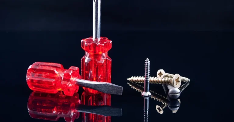 hand turning a small screw with a screwdriver during a repair job