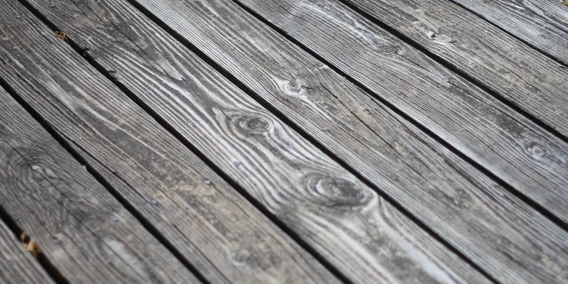Weathered wood deck planks showing natural grain before cleaning