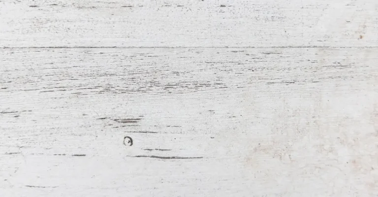 close-up of white painted shiplap wood plank wall showing horizontal board seams