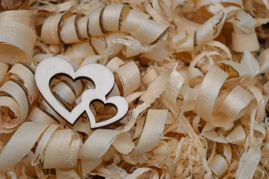 Wooden heart cutouts resting on a bed of wood curls