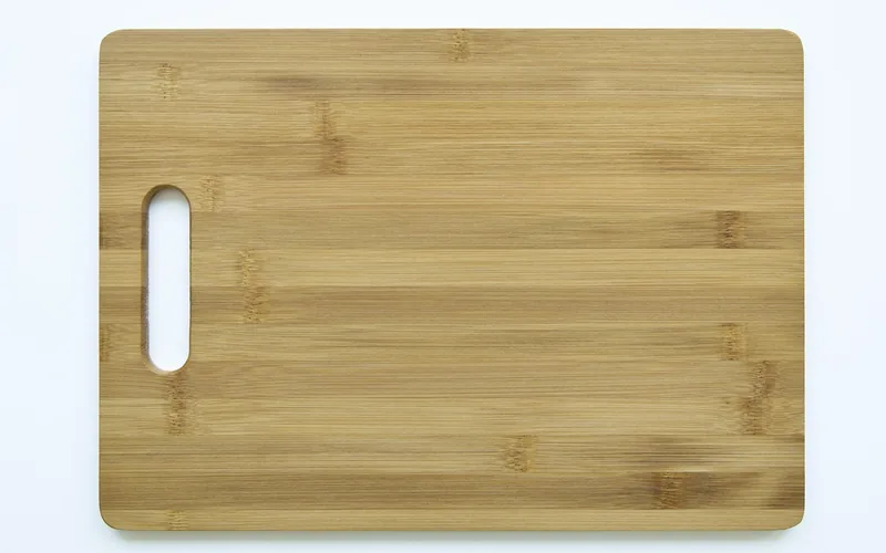clean empty wood cutting board on a kitchen table ready for oiling
