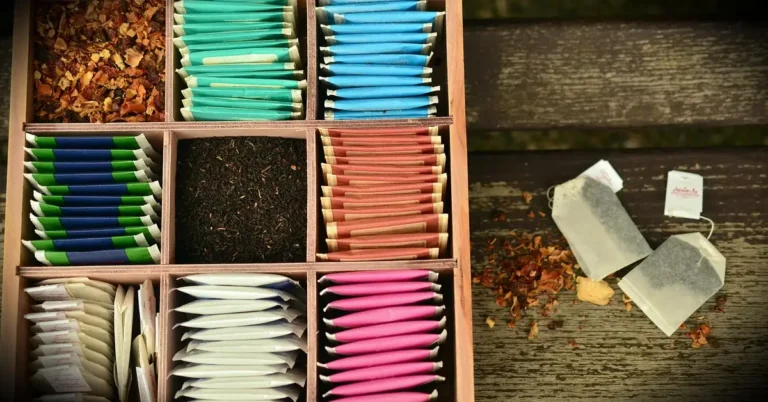 wooden tea box with divided compartments neatly filled with assorted tea bags