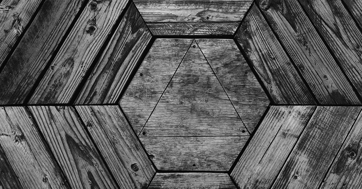 Wooden triangle set inside a hexagon of angled wood planks