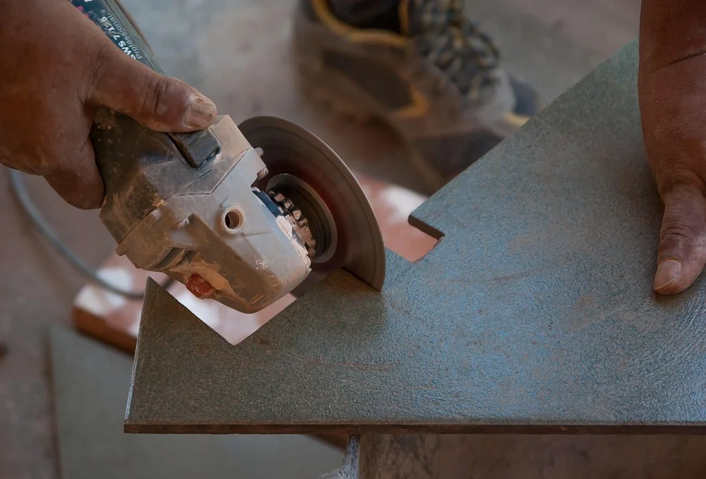 Cutting a porcelain tile to size with an angle grinder
