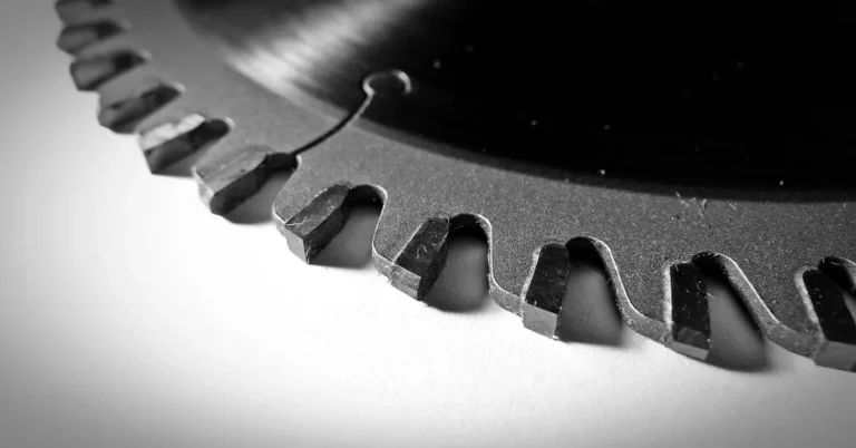 Close-up of carbide-tipped miter saw blade teeth showing tooth spacing and gullet size