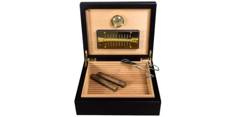 open wooden cigar humidor lined with cedar showing cigars, hygrometer, and cutter