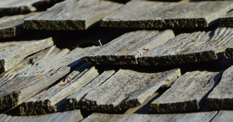 Weathered wood shingles showing the natural gray patina cedar develops outdoors without a finish