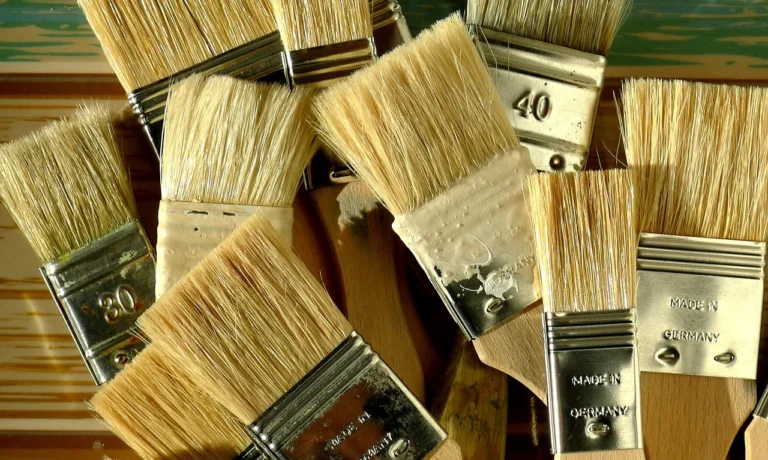 Several clean paintbrushes with dry bristles after washing out water-based polyurethane