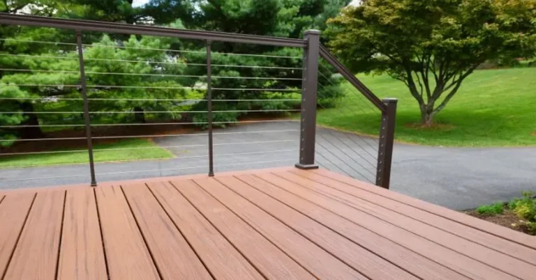 Composite deck with cable railing showing the material's natural wood-look grain