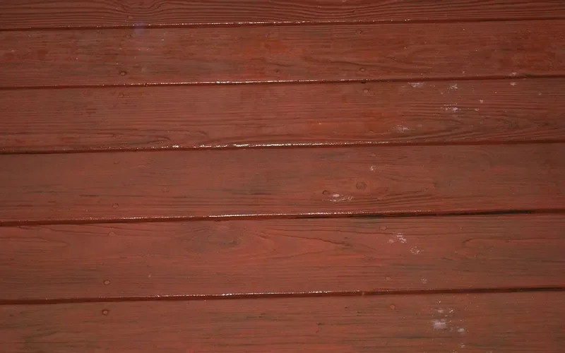 Close-up of damp deck boards with water droplets on the surface
