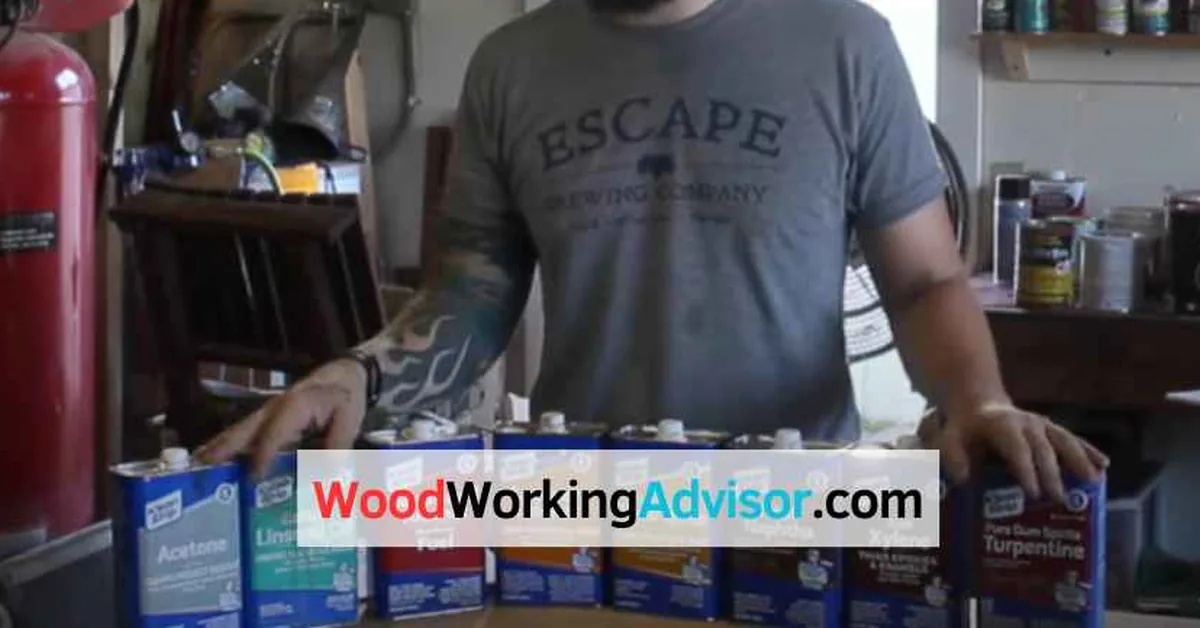 assorted solvent cans including denatured alcohol and mineral spirits arranged on a woodworking workshop bench