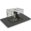 Extra-large waterproof mat with raised edge placed under a dog crate on hardwood floor