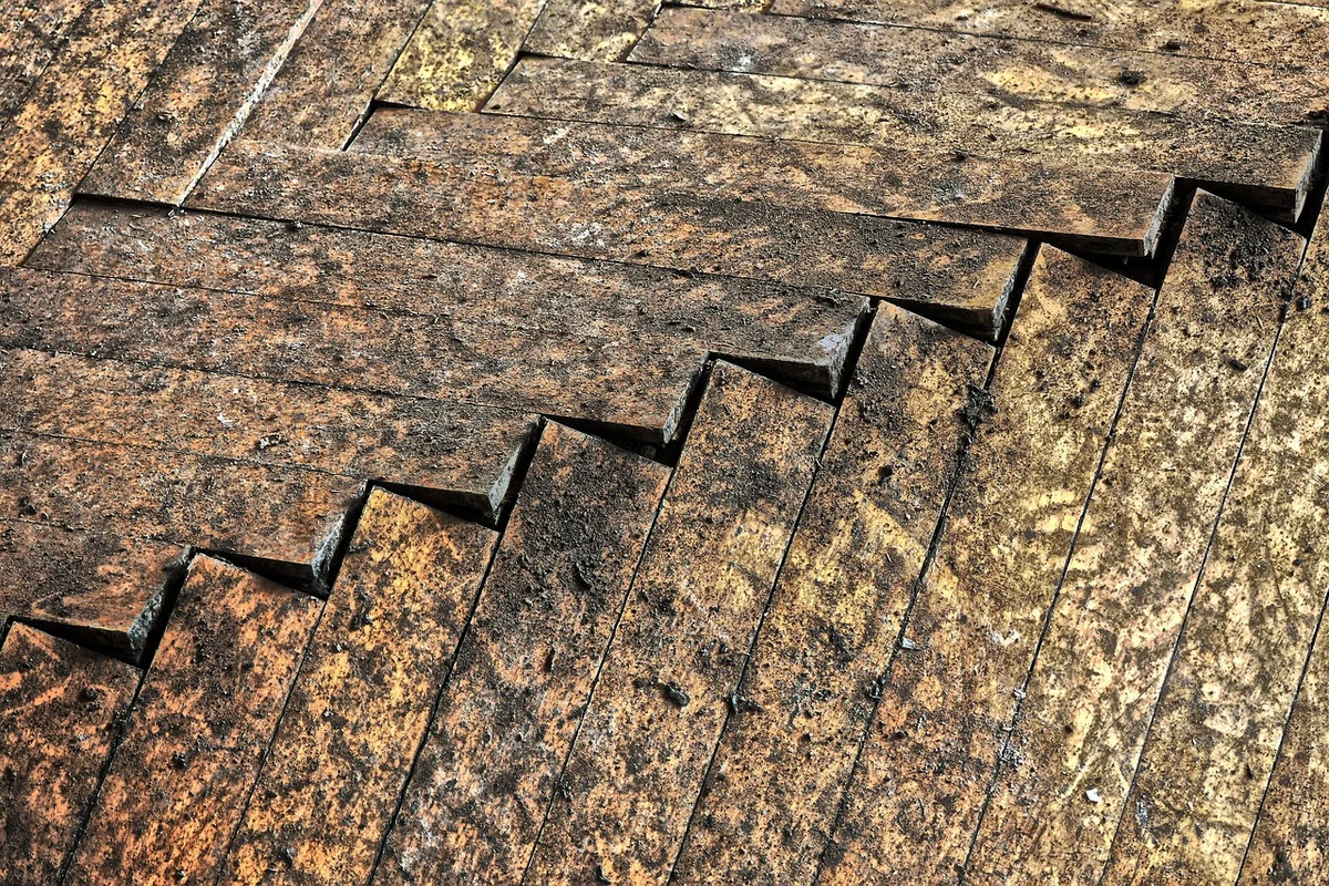 Engineered hardwood flooring buckled and cupped from prolonged water exposure