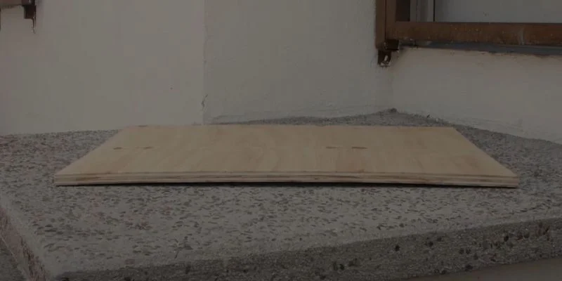 Warped plywood sheet with a visible bow, ready to be flattened