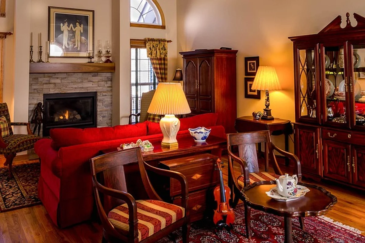 Living room furniture including chairs and a cabinet resting on a hardwood floor