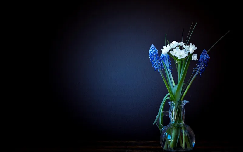 glass insert vase holding fresh cut flowers and water