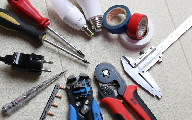grounding wire, screwdrivers, and crimping tools laid out for a dust collection grounding kit install