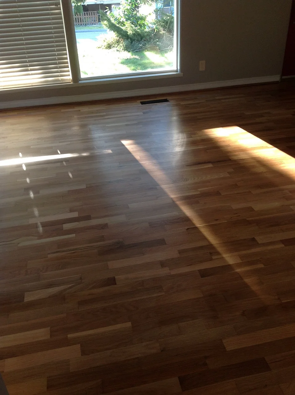 Glossy hardwood floor finished with multiple coats of polyurethane