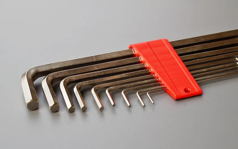 SAE and metric hex key set used to loosen and retighten miter saw fence and detent bolts