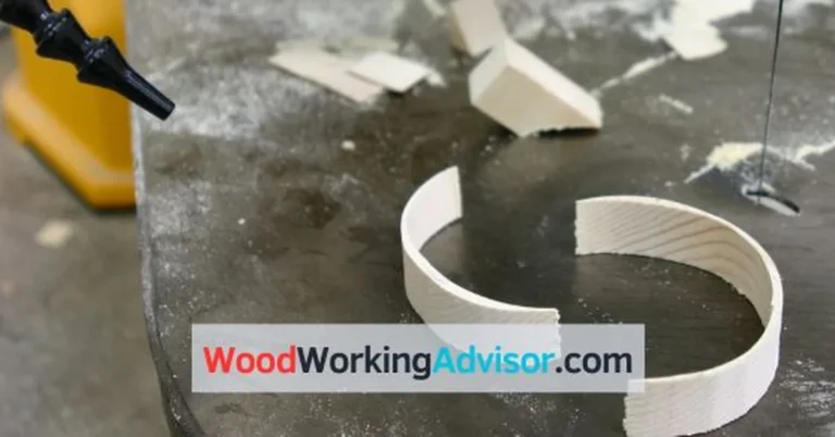 Hitachi CW40 scroll saw cutting a curved wood ring on the cast iron table