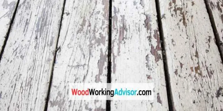Peeling paint on a wood deck board