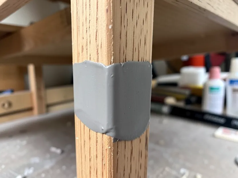 A wood furniture repair filled with epoxy, sanded smooth and ready to paint