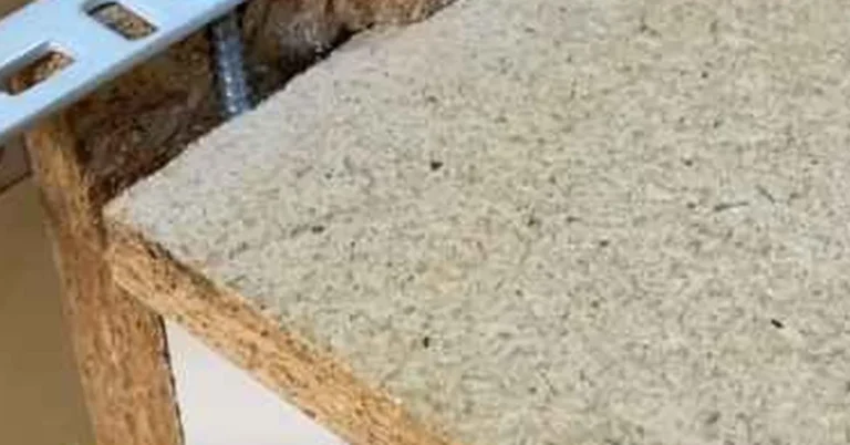 metal corner bracket and screw reinforcing an MDF board edge joint