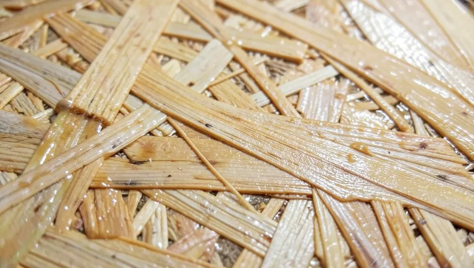 Close-up of OSB oriented strand board surface showing the wood strand and resin pattern