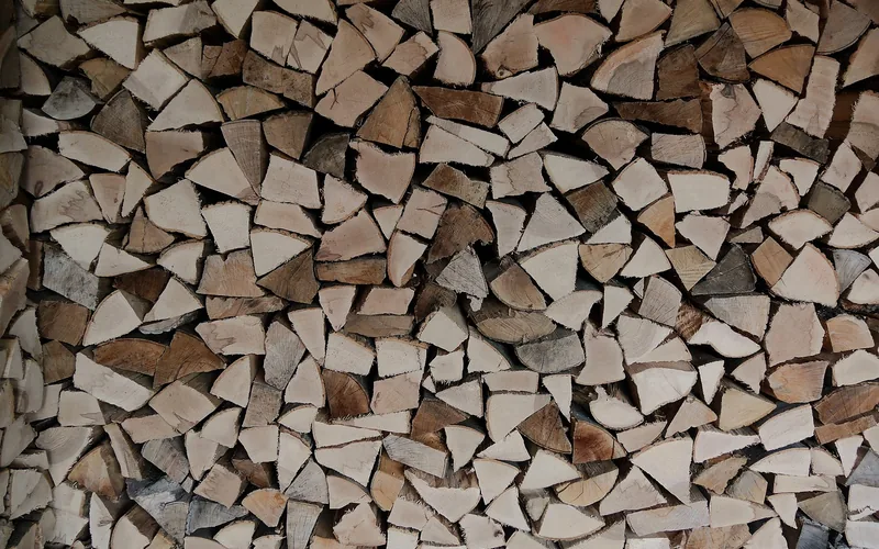 Stacked and seasoned firewood logs split and dried for burning Stacked and seasoned firewood logs split and dried for burning