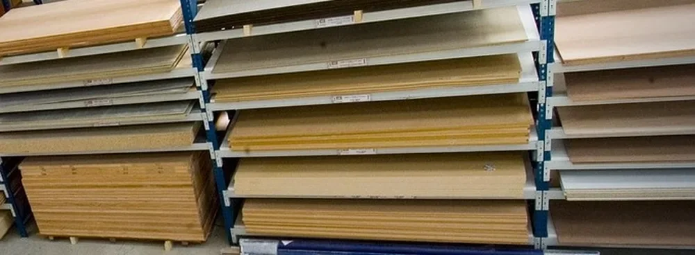 Plywood sheets stored flat on supported racks to prevent warping