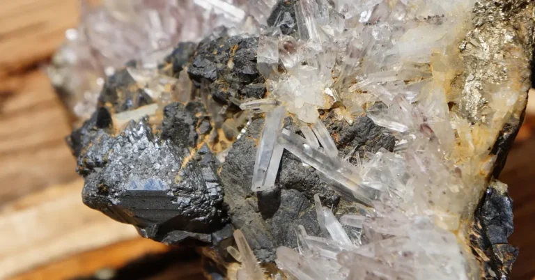 raw quartz crystal cluster resting on a cut wood surface, showing the mineral crystalline structure wood lacks