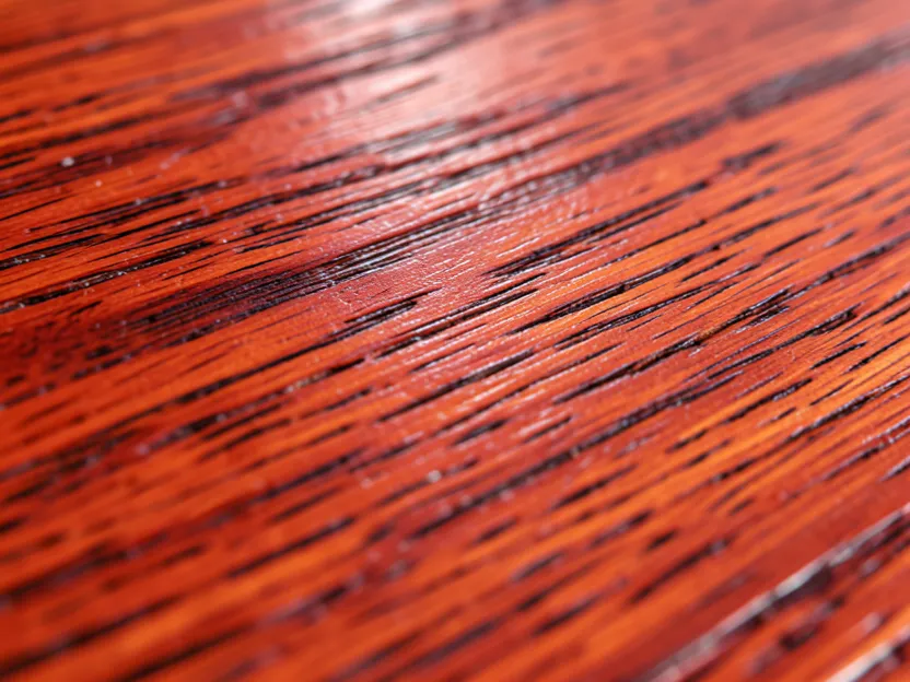 Close-up of finished red oak furniture showing its open, prominent grain pattern