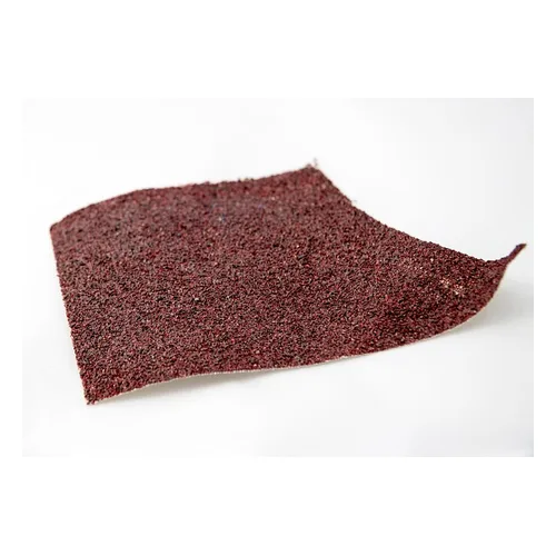 Sandpaper being used by hand to smooth a rounded wood surface