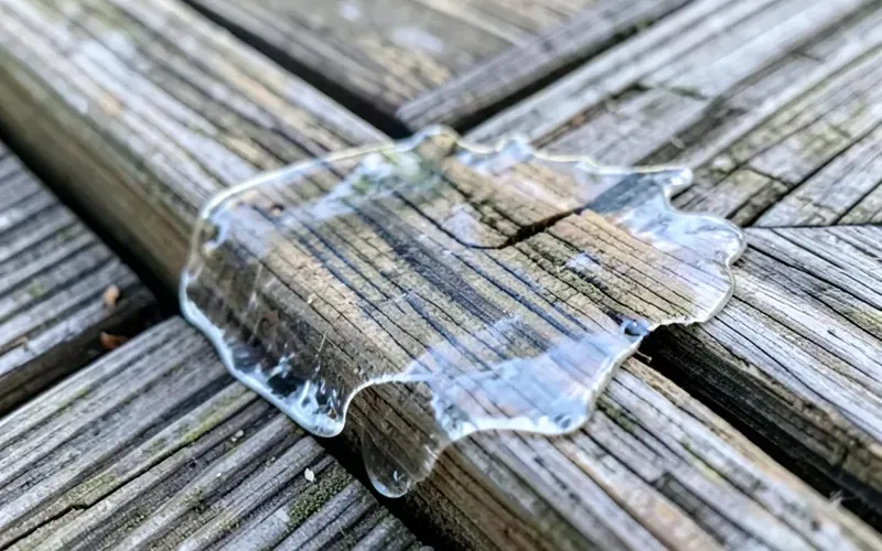 peeling clear wood sealant on a deck board clear wood sealant film peeling and flaking off an outdoor deck board