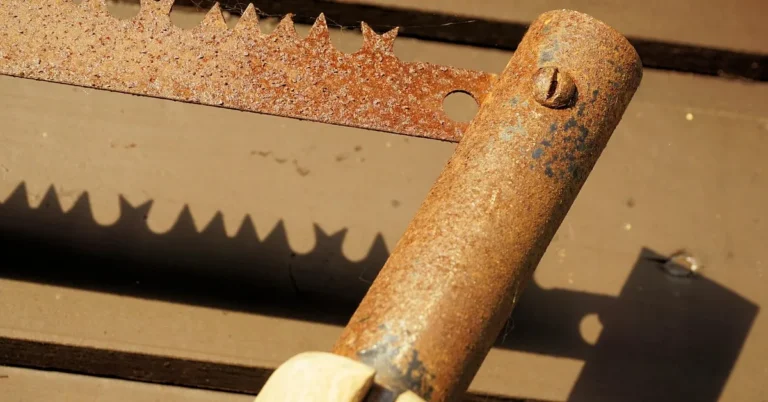 close-up of a rusty hand saw blade with heavy surface corrosion on the teeth