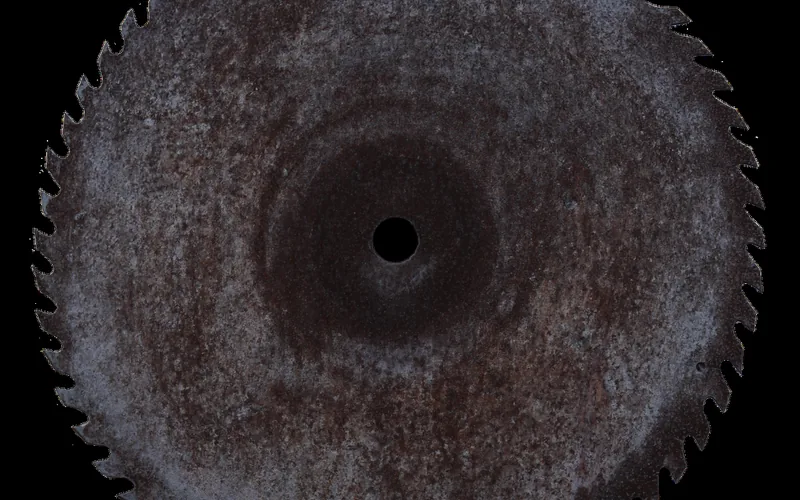 Close-up of a rusted, worn circular saw blade
