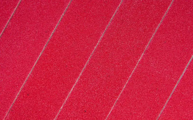 Close-up of fine abrasive sandpaper sheets used for sanding between finish coats