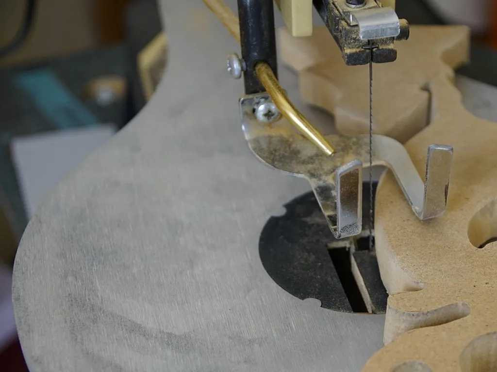 Close-up of a scroll saw blade cutting detailed shapes into wood