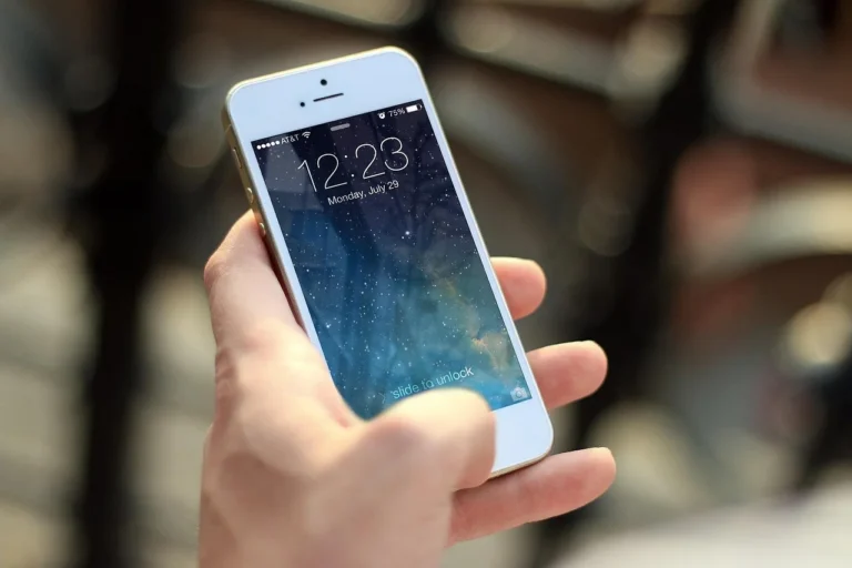 Person holding a large-screen smartphone showing the display size