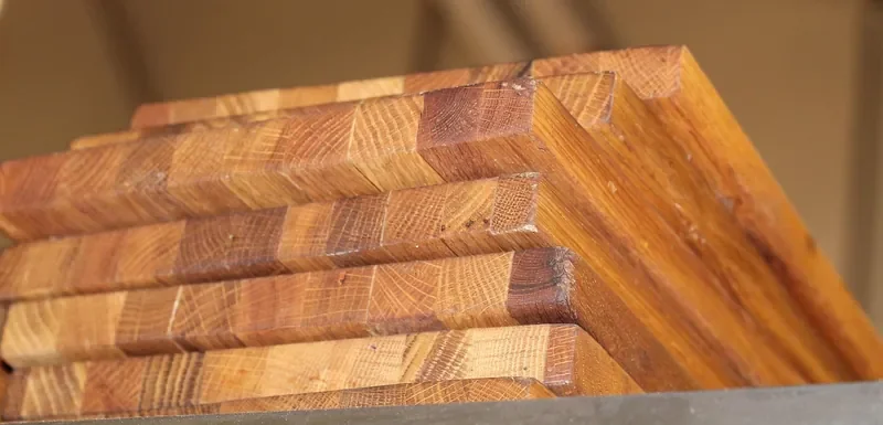 Stack of end-grain wooden boards with a warm oiled finish