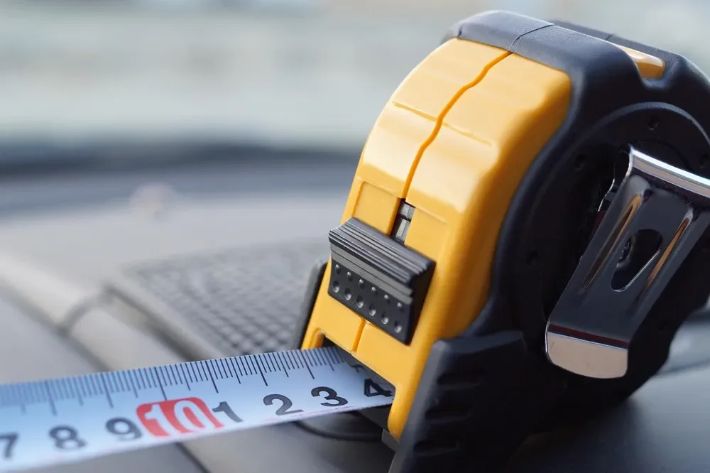 Yellow and black tape measure extended on a surface